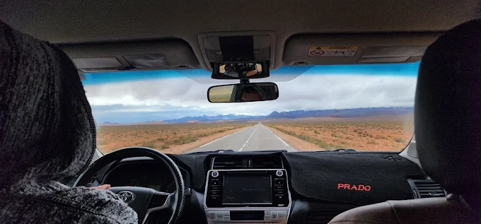 Private driver in Morocco waiting beside a clean vehicle